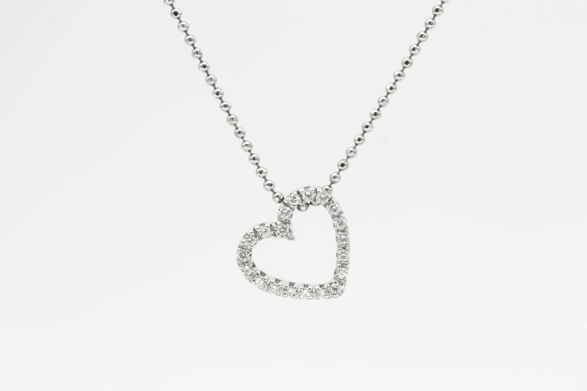 silver heart pendant necklace on white background
