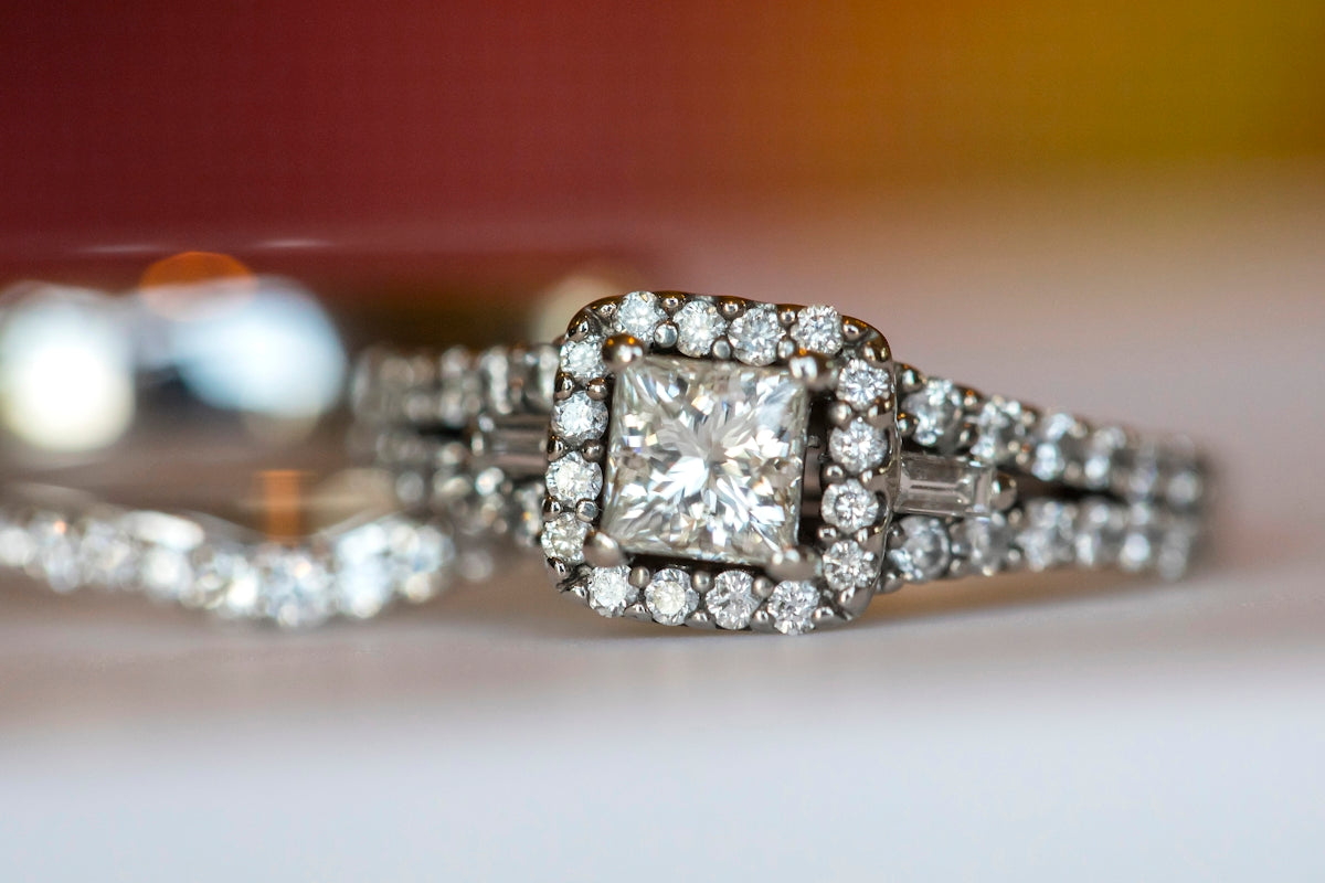 a diamond ring on a white surface