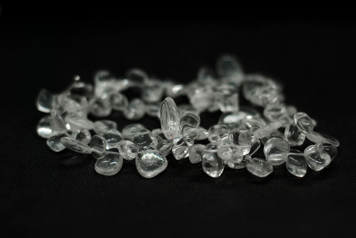 a bunch of glass beads on a black surface