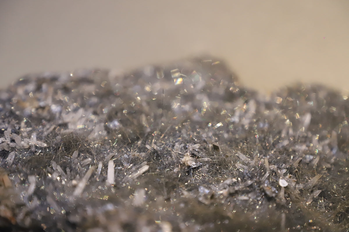 A close up view of a rock with a lot of silver flakes on it