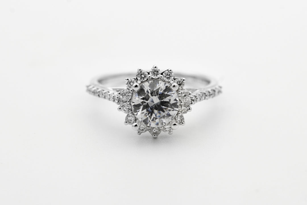 silver diamond studded ring with blue gemstone