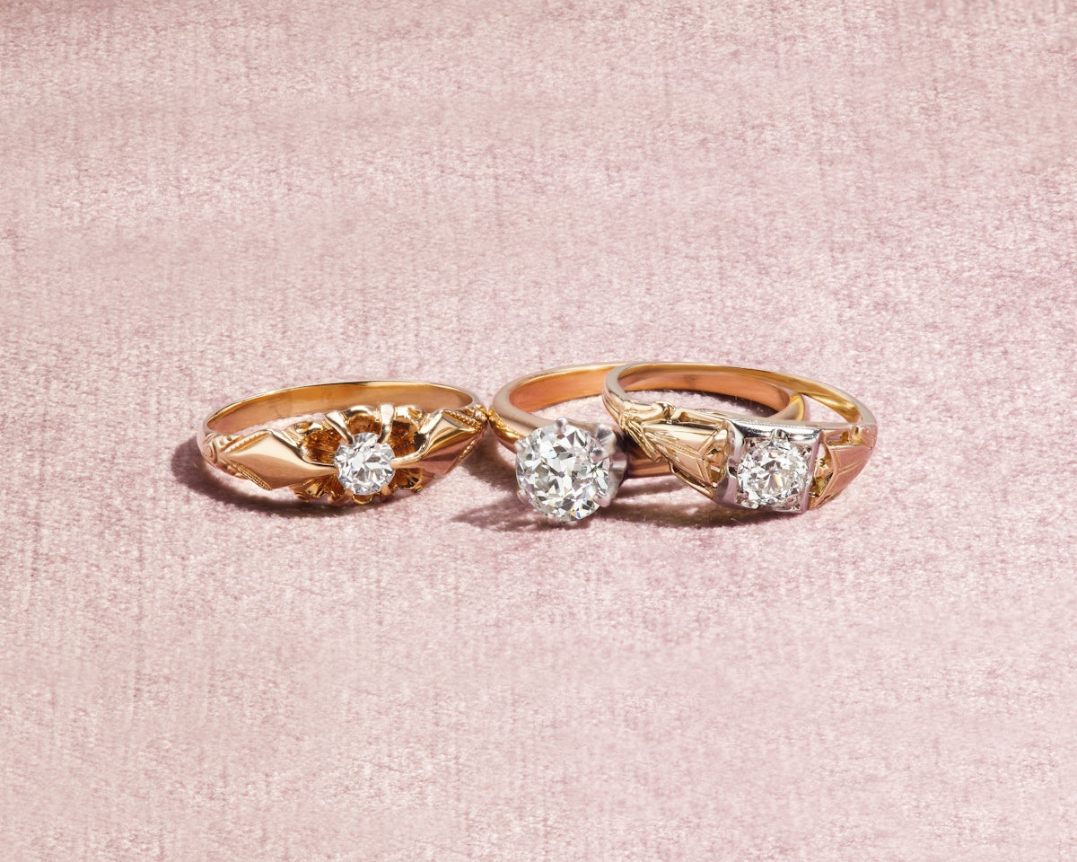 silver and diamond ring on white textile