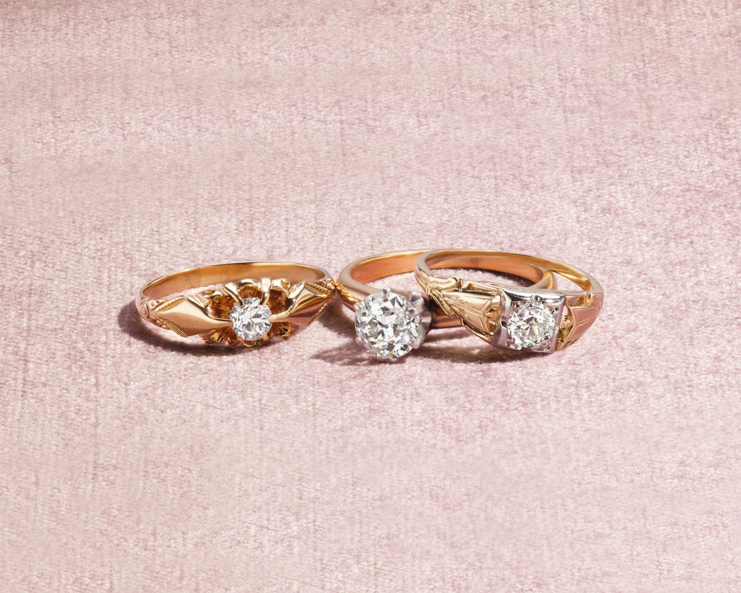 silver and diamond ring on white textile