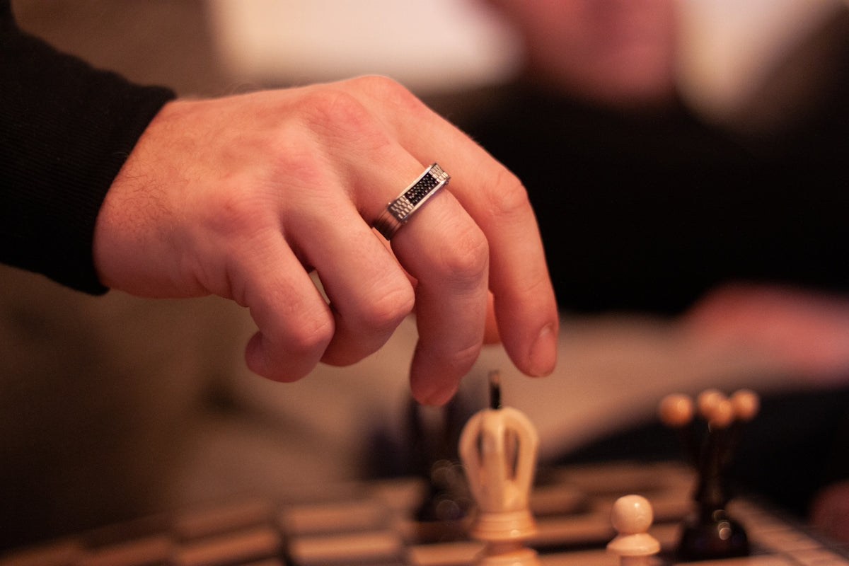person wearing silver ring in tilt shift lens