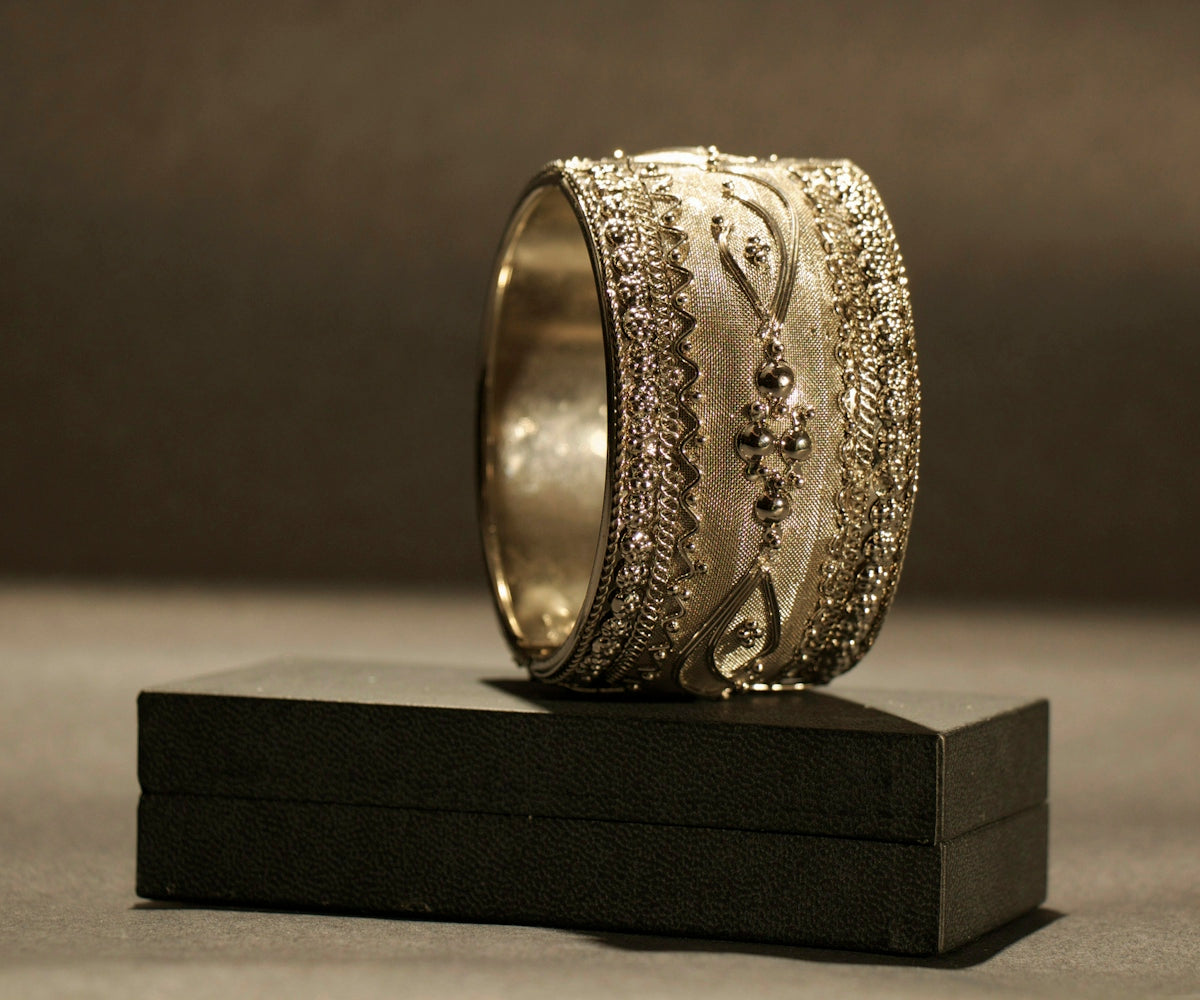 a gold ring with intricate designs on it