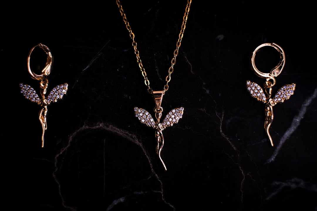 three pieces of jewelry on a black surface