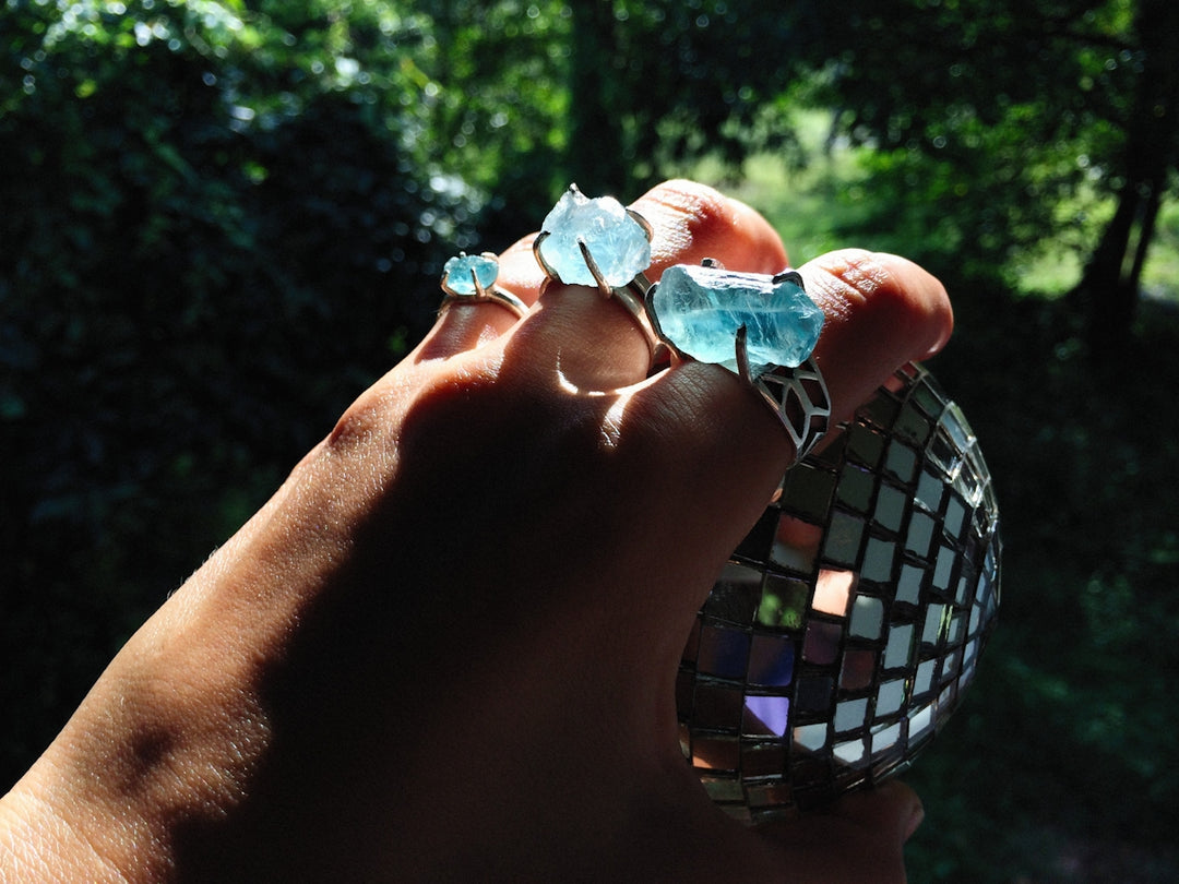 a person holding a disco ball in their hand