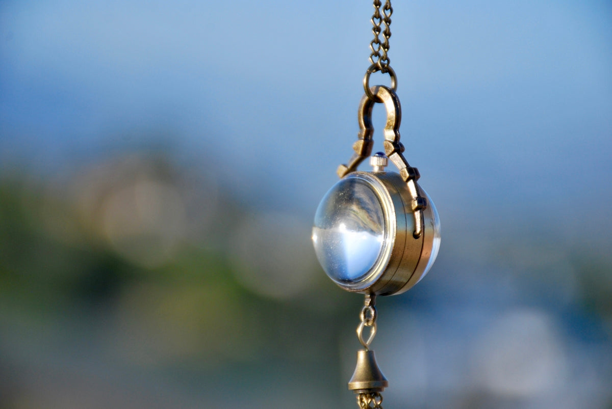 a close up of a light hanging from a chain