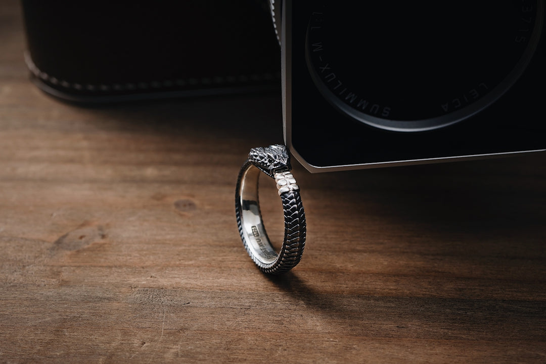 a silver ring sitting on top of a wooden table