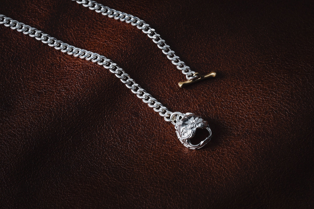 a silver chain with a lock on top of it