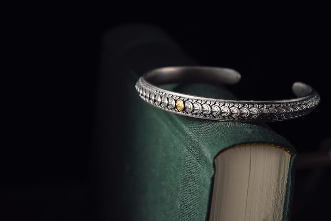 a close up of a book with a ring on it