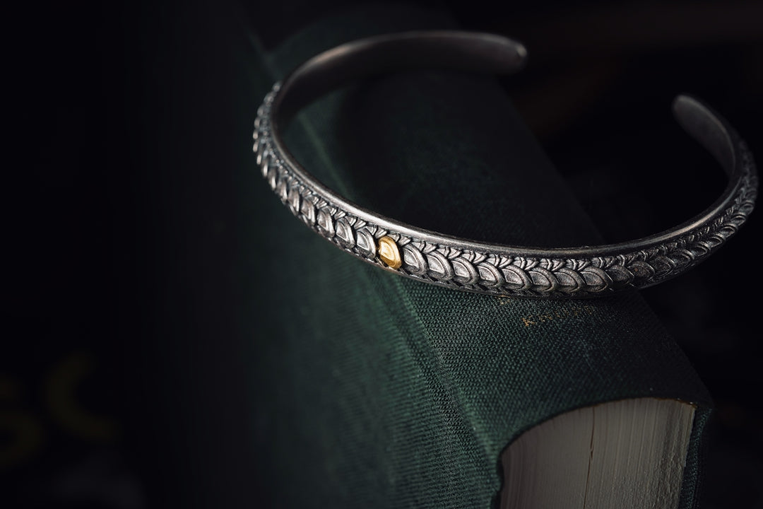 a close up of a book with a bracelet on it