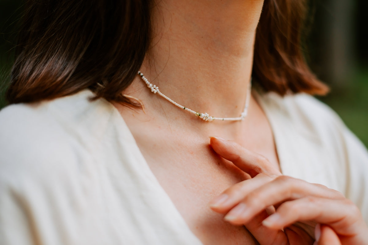 a close up of a woman wearing a necklace