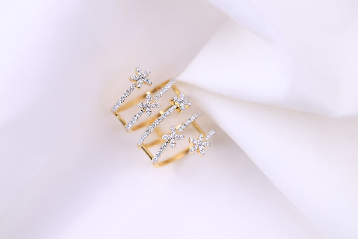 a pair of diamond rings sitting on top of a white cloth