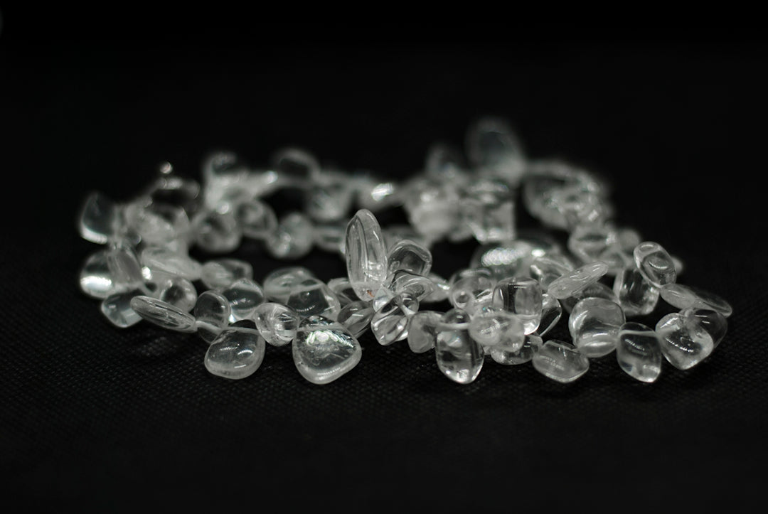 a bunch of glass beads on a black surface