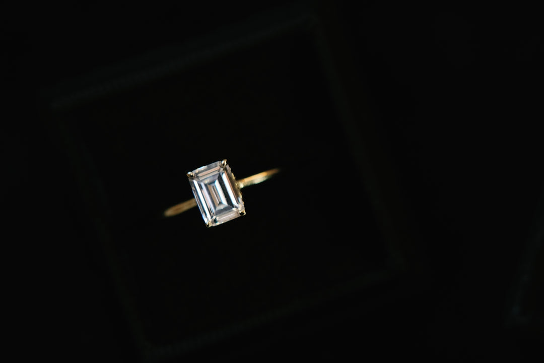 a close up of a diamond ring on a black background