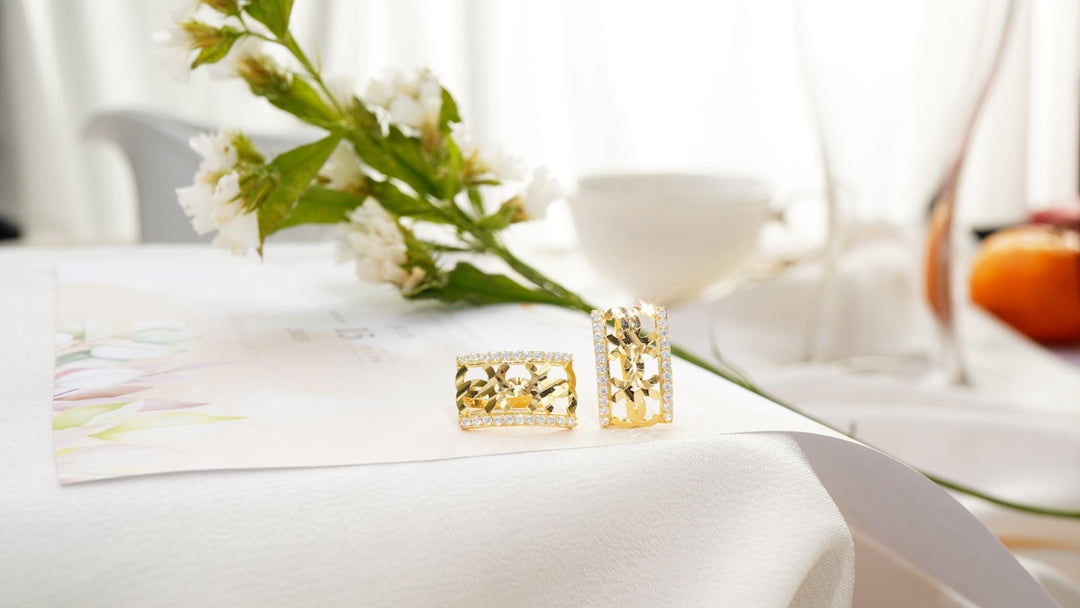 A pair of earrings sitting on top of a table