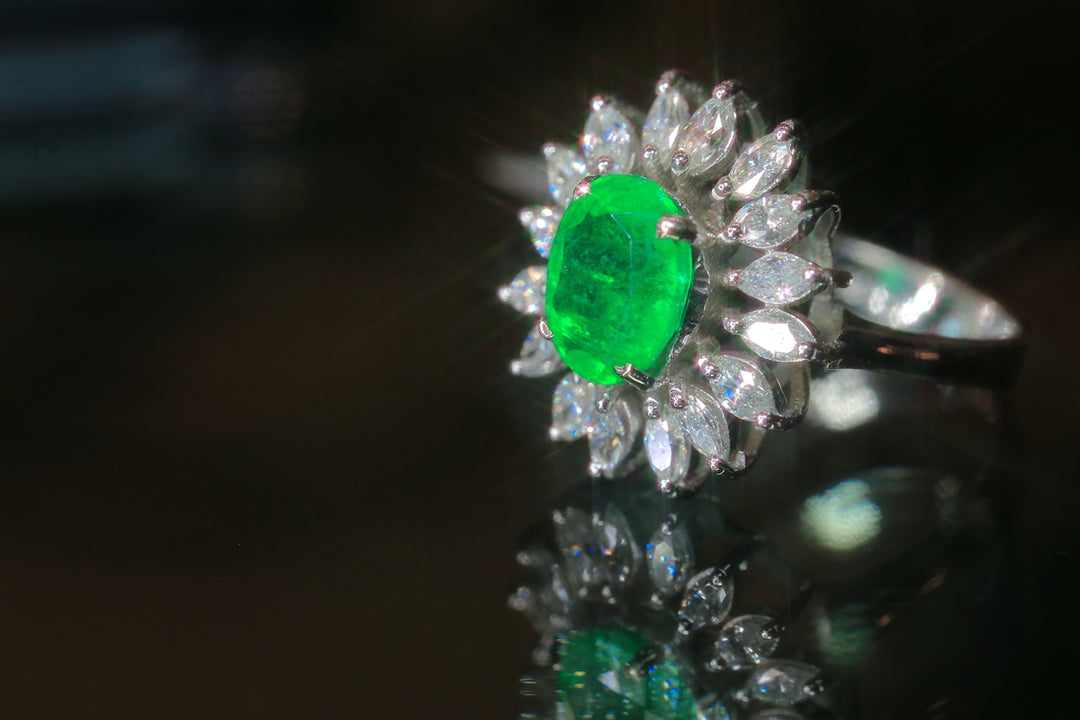A close up of a ring with a green stone