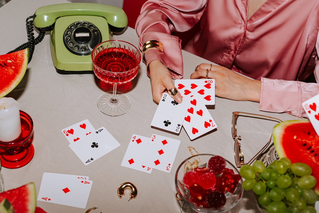 A woman sitting at a table playing cards