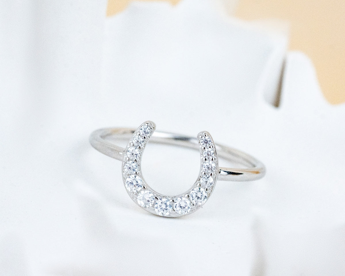 A diamond ring sitting on top of a white flower