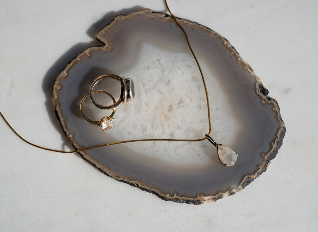 A couple of rings sitting on top of a piece of wood