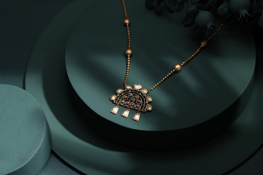 A necklace with a turtle on it sitting on a table