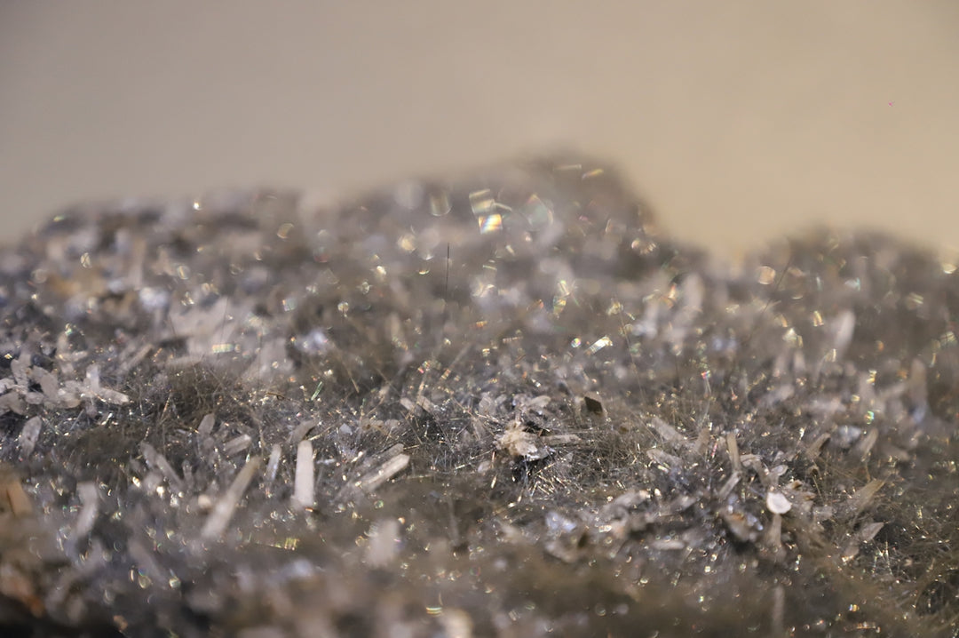 A close up view of a rock with a lot of silver flakes on it
