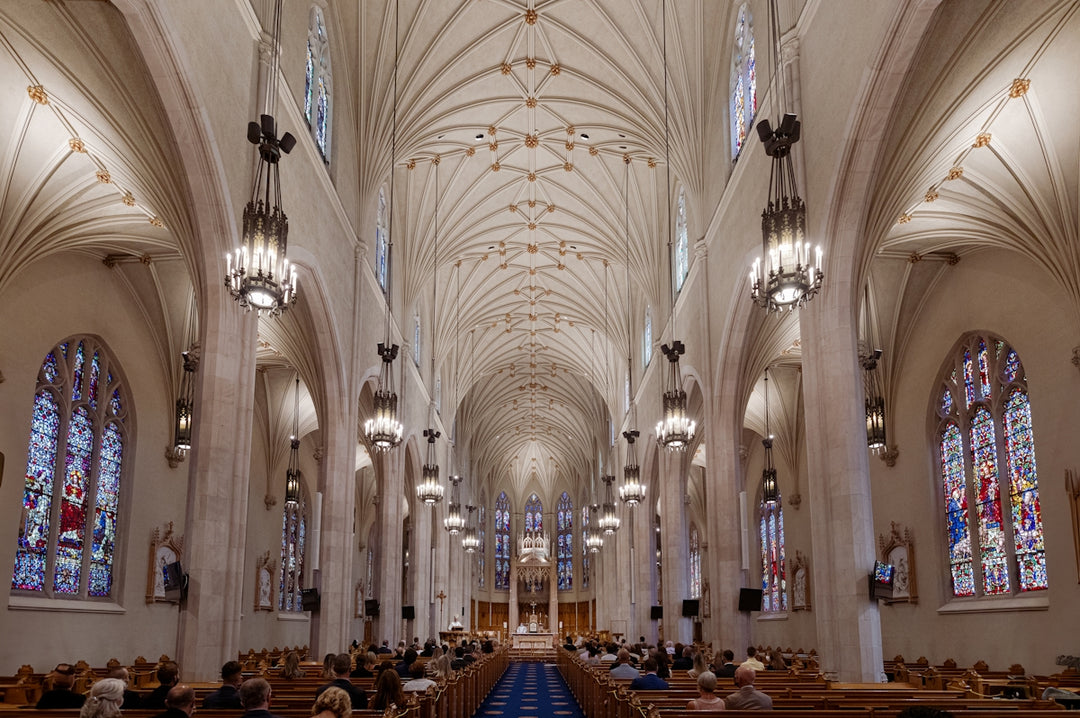A large cathedral with stained glass windows and pews
