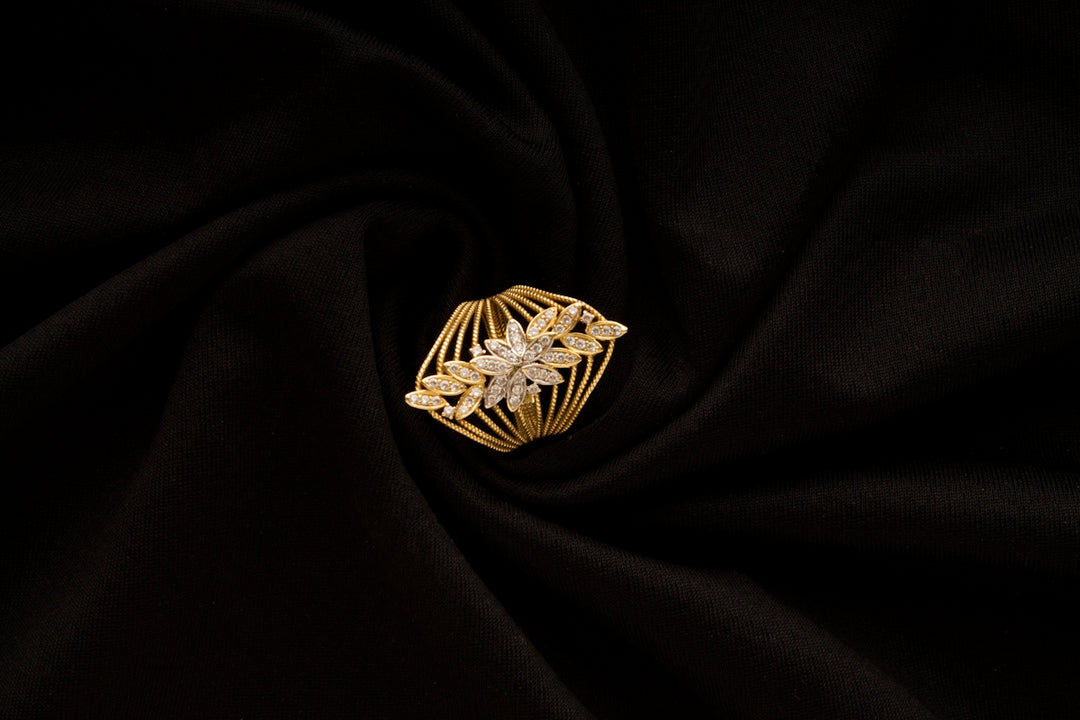A gold ring sitting on top of a black cloth