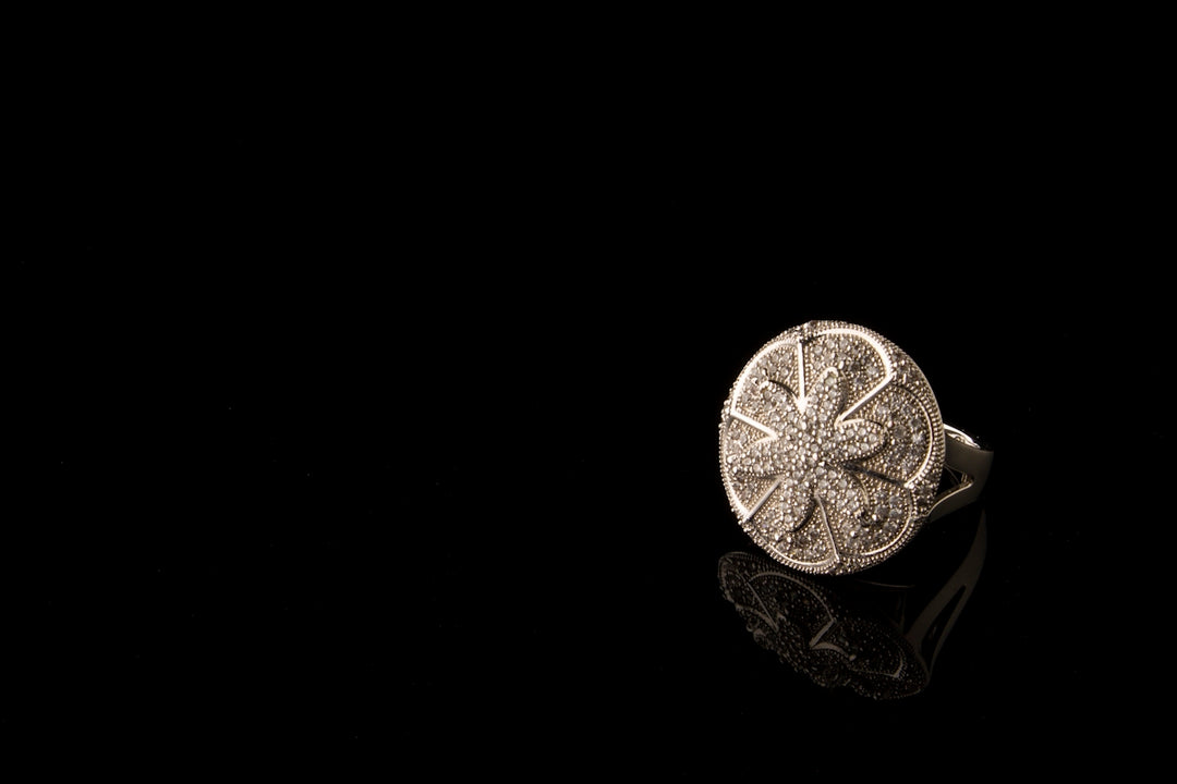 A silver ring with a flower on it