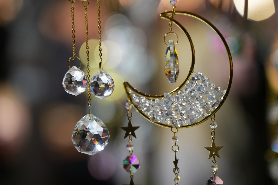 A close up of a wind chime with a crescent and stars