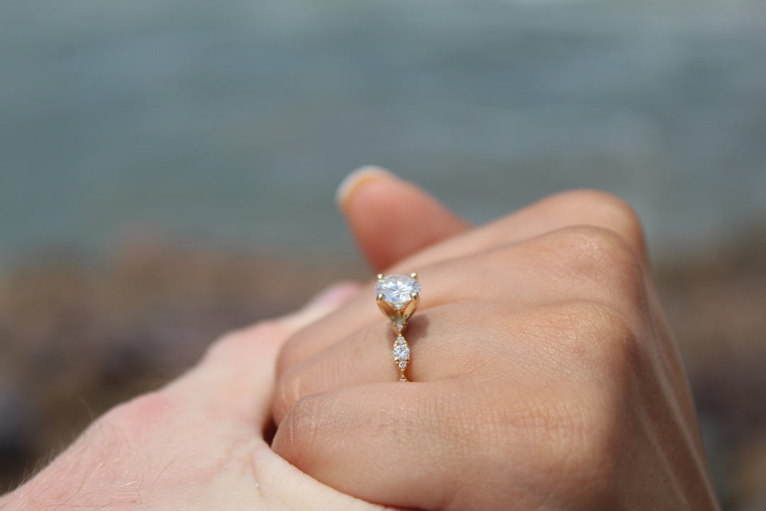 A hand shows off a beautiful engagement ring.