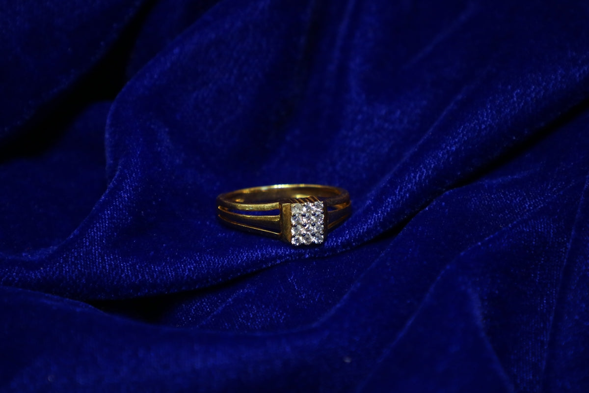 A gold ring with diamonds on blue silk