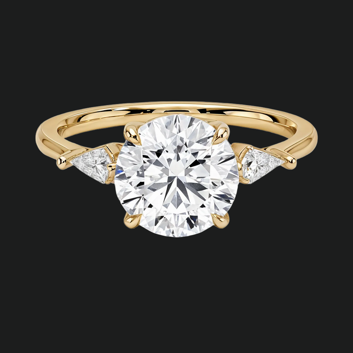 Cometa Three Stone Round Diamond Accenten verlovingsring in 9kt witgoud