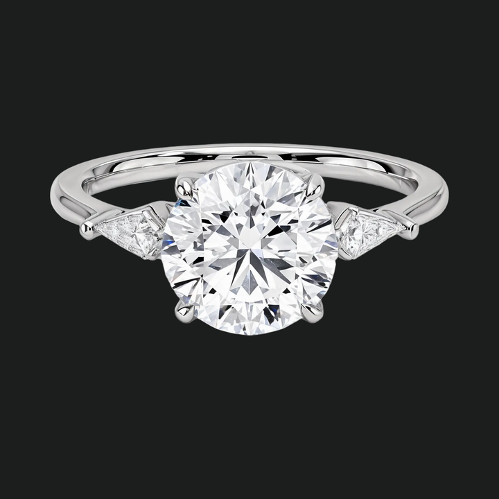 Cometa drie stenen ronde diamant accenten verlovingsring